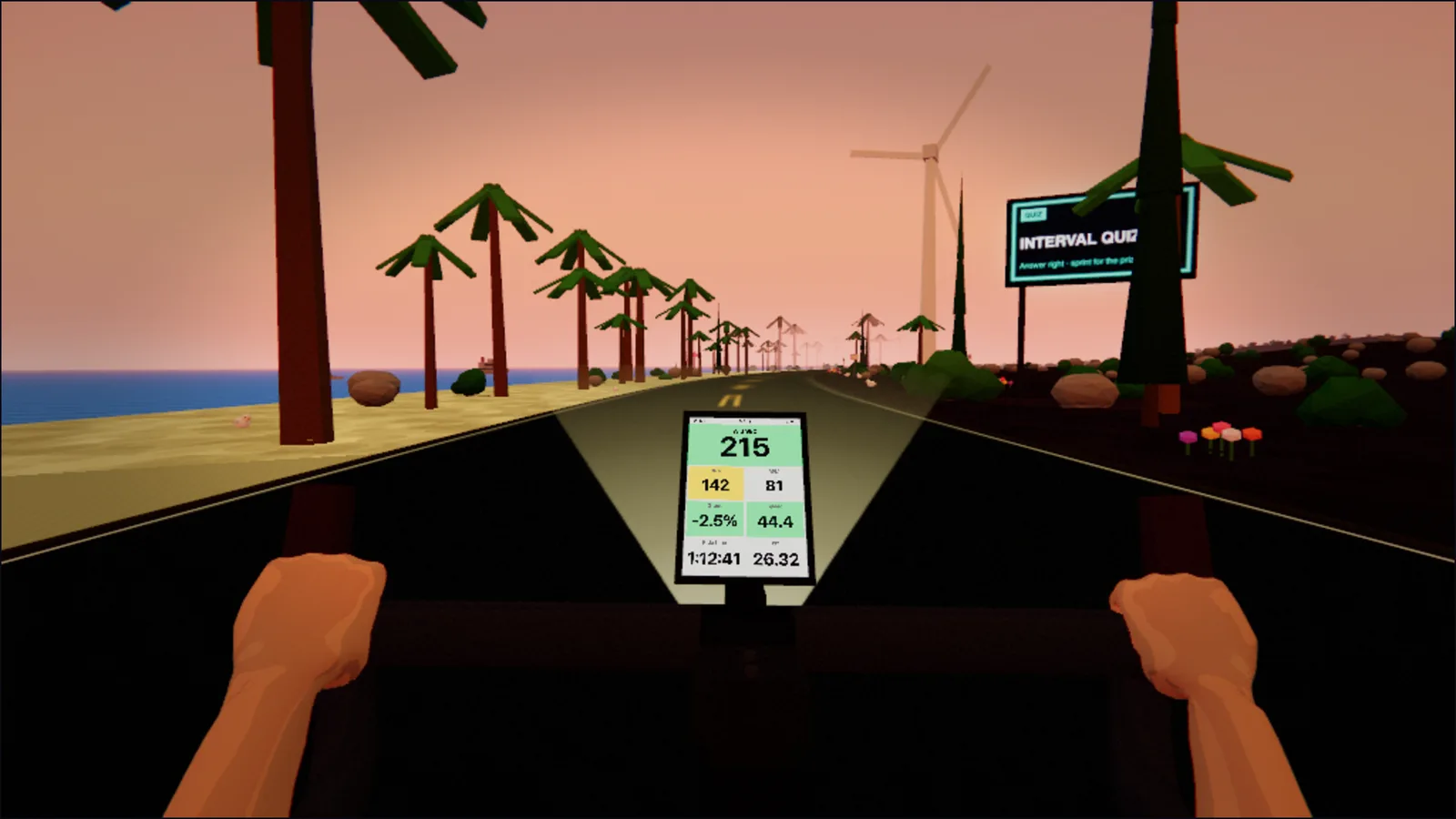 Coast road in morning light: palms line both sides, the sea flashing between the trunks on the left, a wind turbine turning above the bank on the right, pink sky to the horizon.